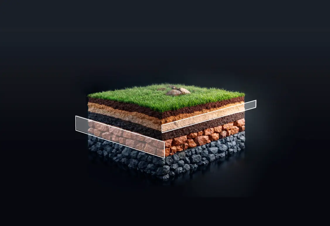 inspiración para logo de Vodem: La imagen muestra un bloque tridimensional en corte, como una sección del suelo. En la parte superior hay césped con algunas piedras, y debajo se observan varias capas diferenciadas: tierra, arena y distintos tipos de rocas más compactas hacia la base. Dos recuadros semitransparentes resaltan capas específicas, sugiriendo un enfoque explicativo o técnico de la composición del terreno.